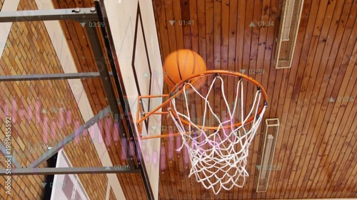 Teen shooting in gym for coaching, ball hitting rim, net stretching, graphs drifting over backboard