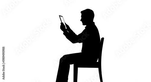Man sitting on chair using tablet.