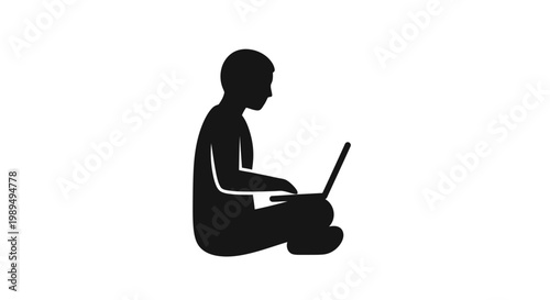 Silhouette of a person using laptop.