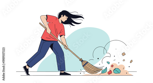 Energetic woman using a traditional broom to sweep up a pile of colorful autumn leaves and debris on the ground.