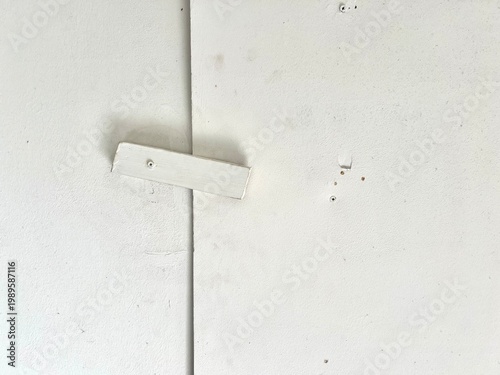 Obraz na plátne A simple white wooden bar latch screwed onto a white wall or door as a temporary locking mechanism