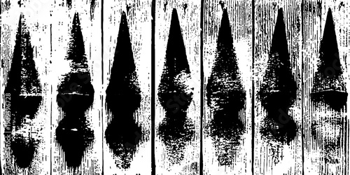 Wooden picket fence with pointed tops against textured panels