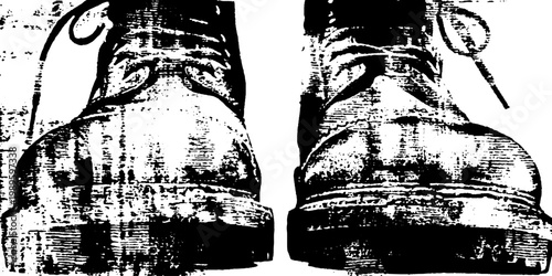 Pair of worn boots standing on scuffed wooden floor planks