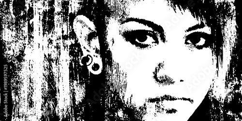 Young person looking at camera with ear piercings on textured wall