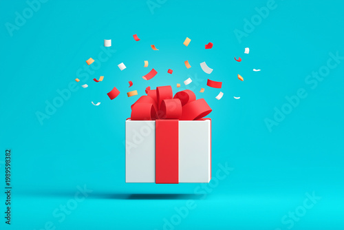 White gift box with red ribbon opening and confetti flying on blue background