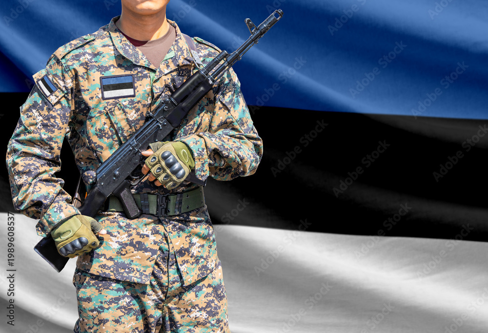 Fototapeta premium Estonia flag with soldier holding assault rifle