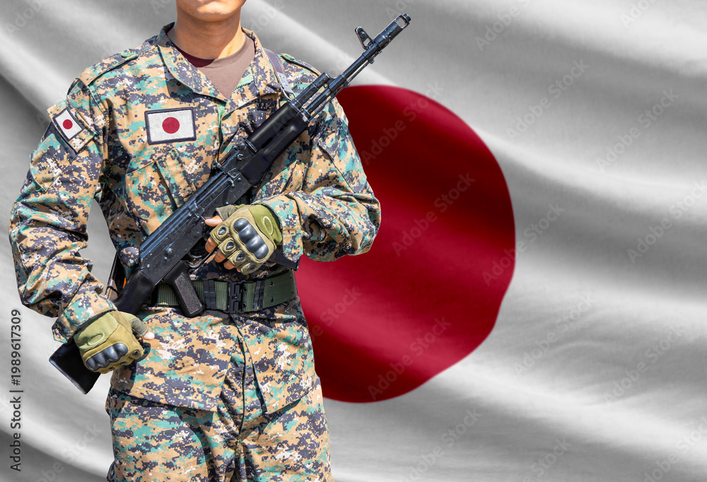 Fototapeta premium Japan flag with soldier holding assault rifle
