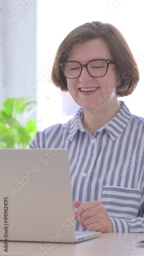 Online Video Call by Senior Woman in Office, Vertical Video