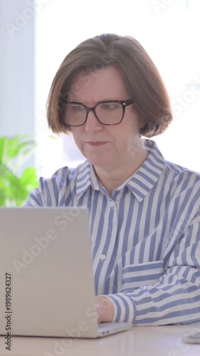 Frustrated Senior Woman Working on Laptop in Office, Vertical Video