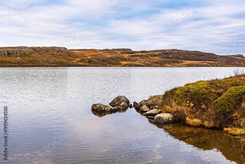 Blick über einen See auf die Landschaft im Osten von Island