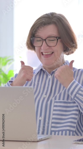Senior Woman Celebrating Online Success in Office, Vertical Video