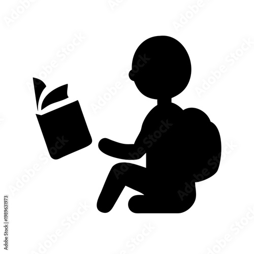 Silhouette of a student sitting and reading a book