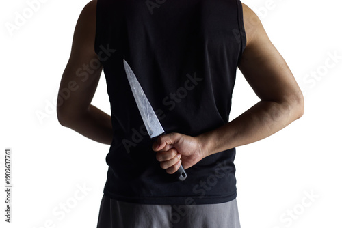 The Hidden Blade: Person with Concealed Kitchen Knife Behind Their Back
