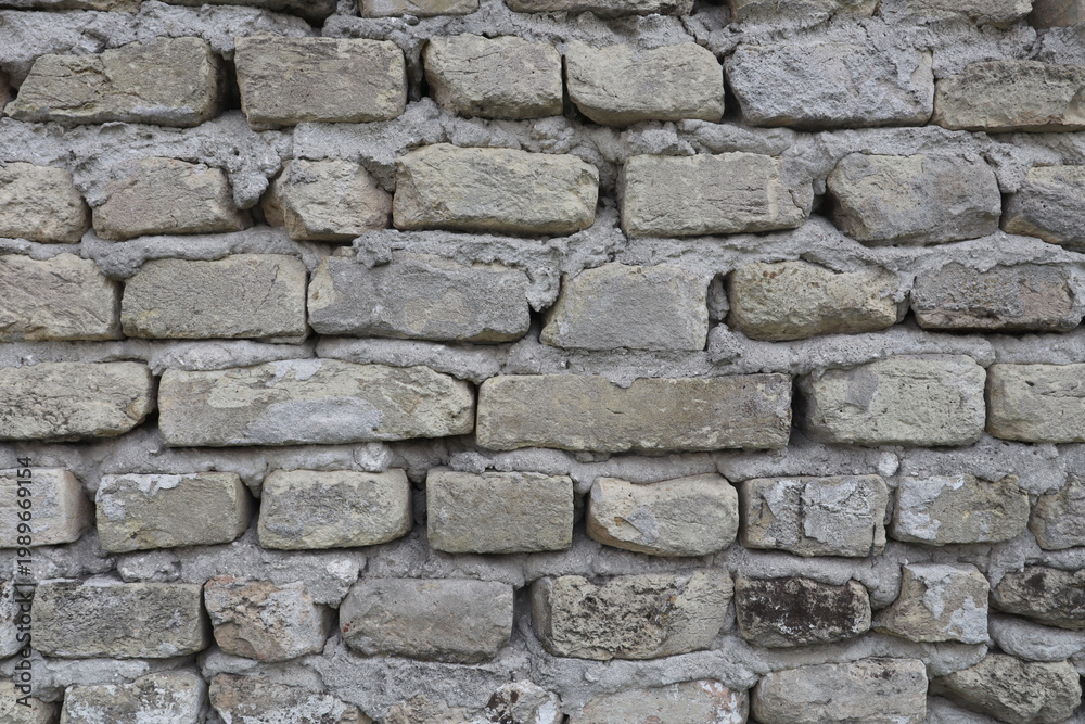 Fototapeta premium An old grey wall with bricks