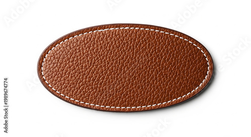 Oval shaped brown leather patch with white decorative stitching isolated on white background for clothing branding
