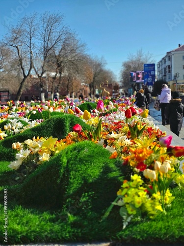 Bright spring flower bed with tulips on a city street.