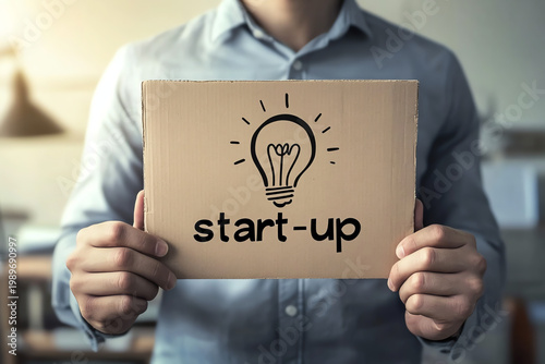 Entrepreneur Holding Start-Up Sign Symbolizing New Business Launch