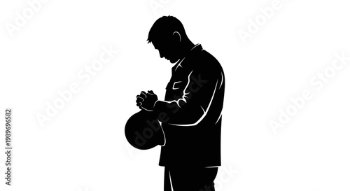 Silhouette of a man holding a basketball in contemplation