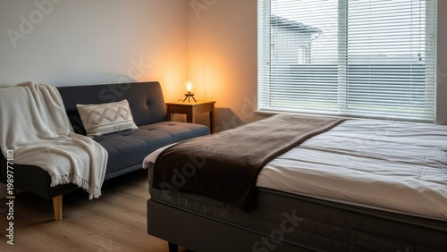A cozy bedroom with a bed and a sofa by the window