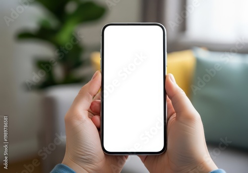 Person holding smartphone with blurred background in a public setting