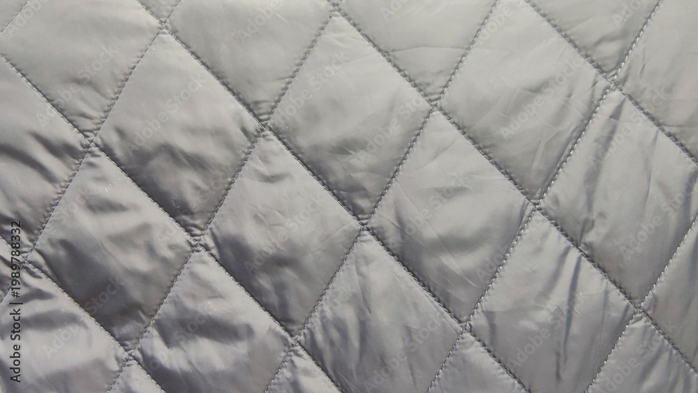Naklejka premium quilted fabric texture gray stitched pattern textile material closeup