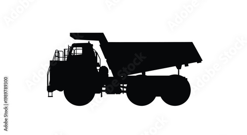 Large mining dump truck shown in a dramatic black silhouette