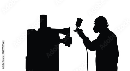 Worker using spray gun with machinery in stark silhouette