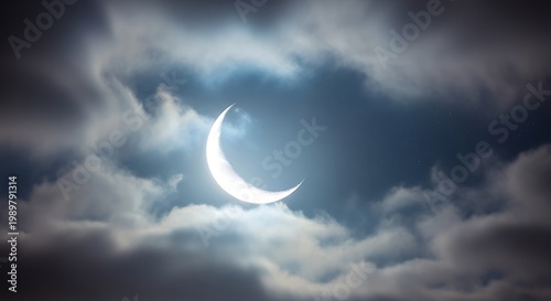 Bright crescent illumination shines through dark, dramatic cloud cover in the night sky