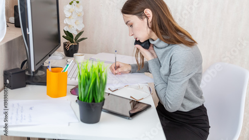 Fényképezés Busy occupied business woman working from home, call at mobile phone, checking emails, reading text messages, making an appointment, using modern technology in home office