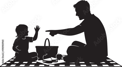Silhouette of a man and a child having a picnic on a blanket with a basket and food