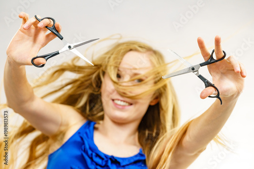 Girl with scissors for haircutting