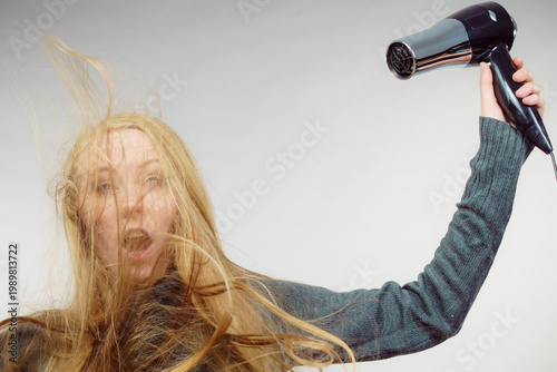 Woman styling her long hair
