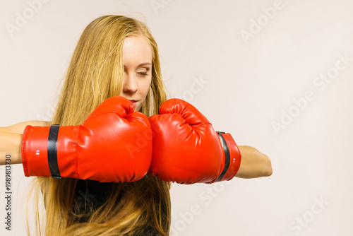 Woman in gloves playing sports boxing