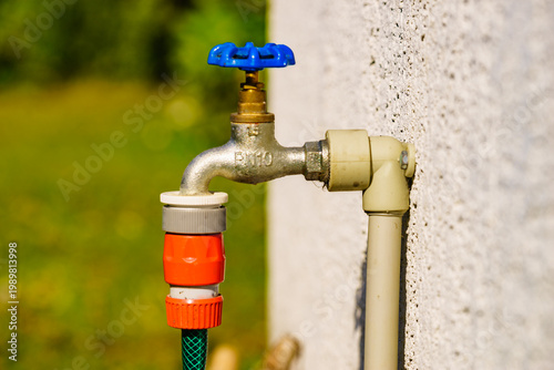 Garden tap with hosepipe attached.