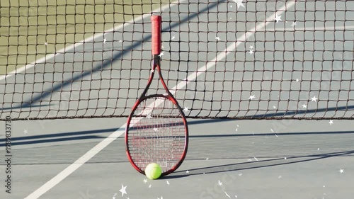 Red-handled racket leaning against net and ball resting, frames causing sparkle overlay for sports