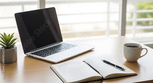 Laptop coffee cup notebook pen and potted plant on wooden table workspace concept modern design