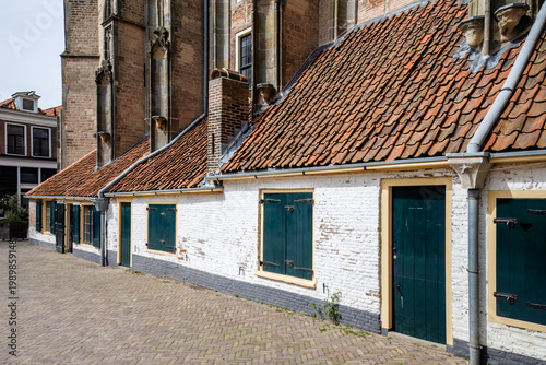Row of white buildings with tile roofs