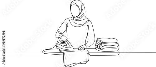 Continuous line illustration of a woman in hijab ironing clothes with folded laundry on the side. One line drawing style showing housework. one line Icon drawing