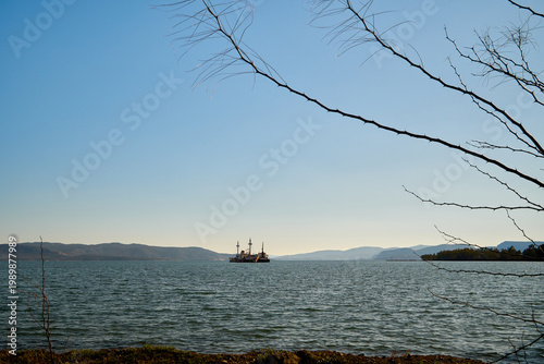 Photography Rusty ships sit quietly on still water
