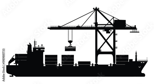 Silhouetted cargo ship being loaded by a large port crane