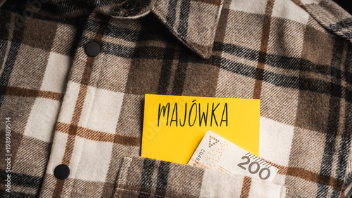 Close-up of a flannel plaid shirt with a yellow card with the inscription 