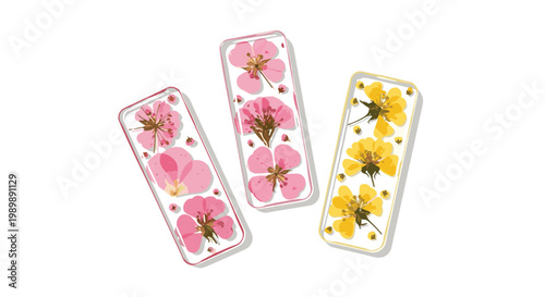 Three exquisite transparent resin bookmarks showcasing meticulously preserved pink and yellow pressed flowers lie scattered across a clean and bright white surface.