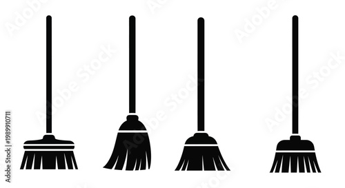 Four black brooms stand against a white background a bold silhouette