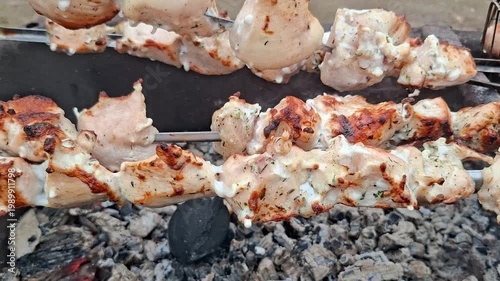 Marinated chicken skewers grilling on charcoal barbecue