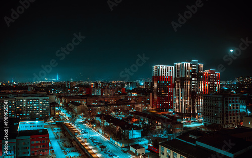 Almaty city skyline at night with illuminated buildings and urban lights