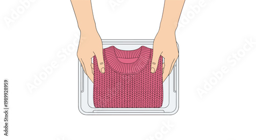 Two hands are shown from a top-down perspective placing a neatly folded vibrant pink knitted sweater into a clear plastic storage container on a white.