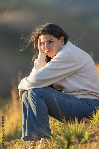 Young woman feeling sad and bored outdoors
