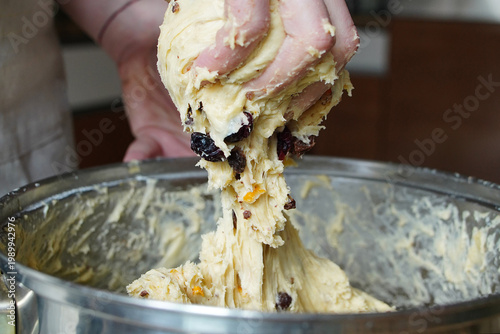 Stretching raw dough out of a pot 