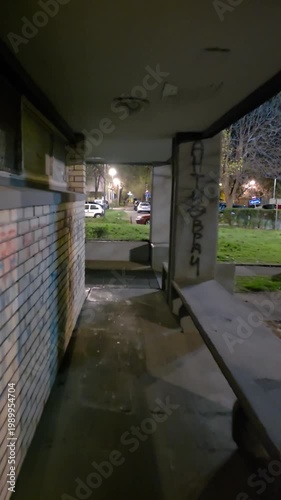 Night View of a Gritty Urban Walkway with Graffiti and Brick Walls