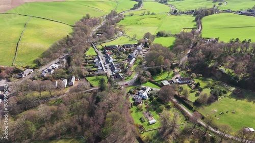 Quiet morning over Eddleston village in the Scottish Borders with stone houses nestled in the lush green valley of Tweeddale.